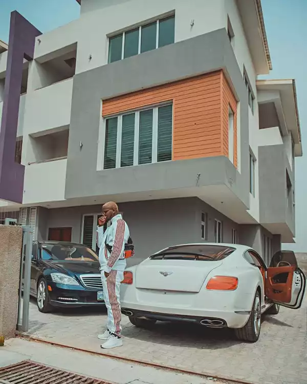 Kizz Daniel Strikes A Pose With His Cars In His New Mansion